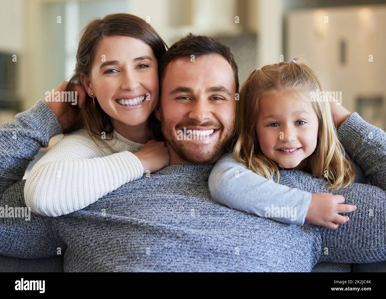 Love lives here. Shot of a young family relaxing on the couch at home. Stock Photo