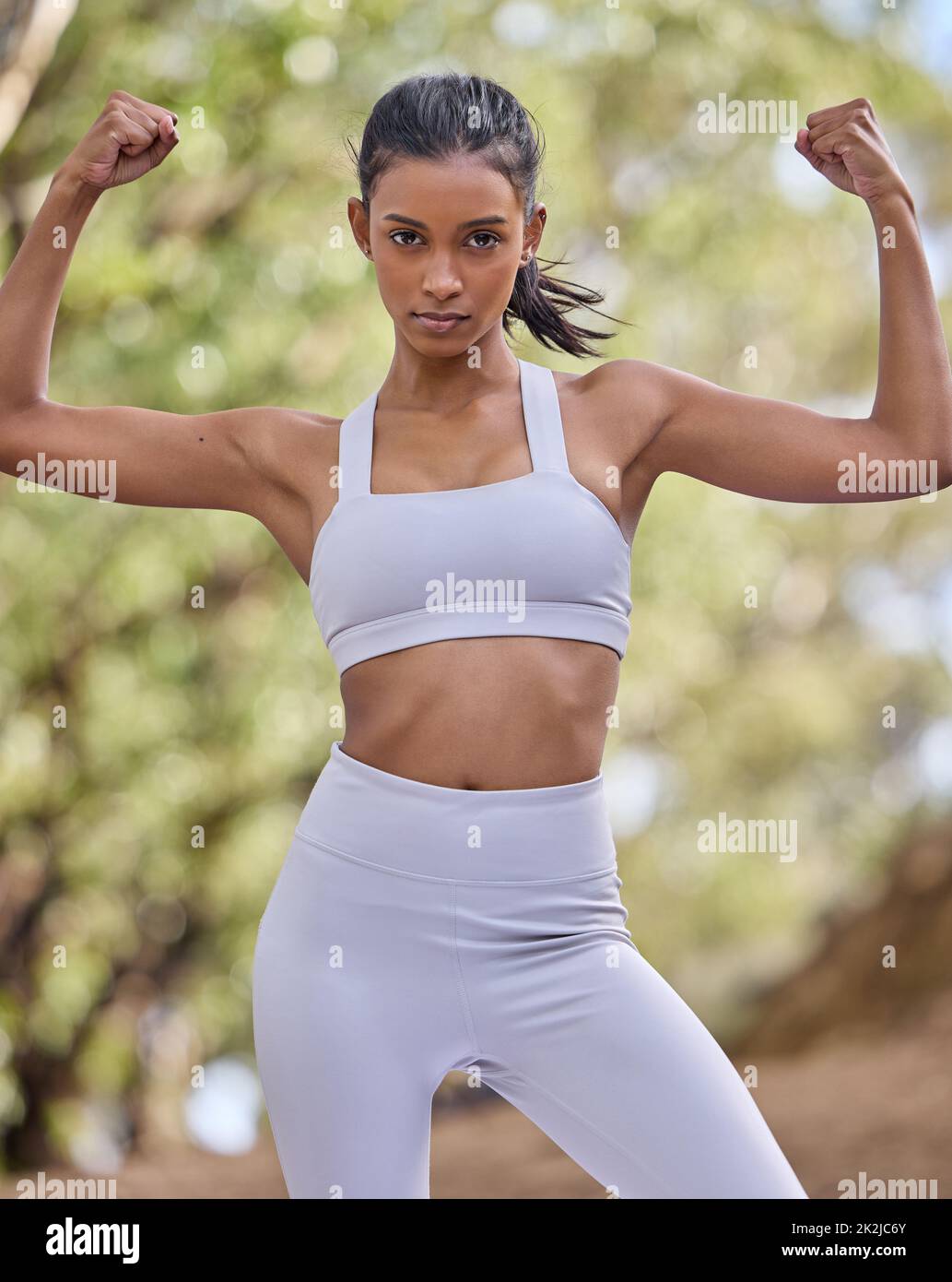 Athletic young woman flexing biceps hi-res stock photography and images -  Alamy