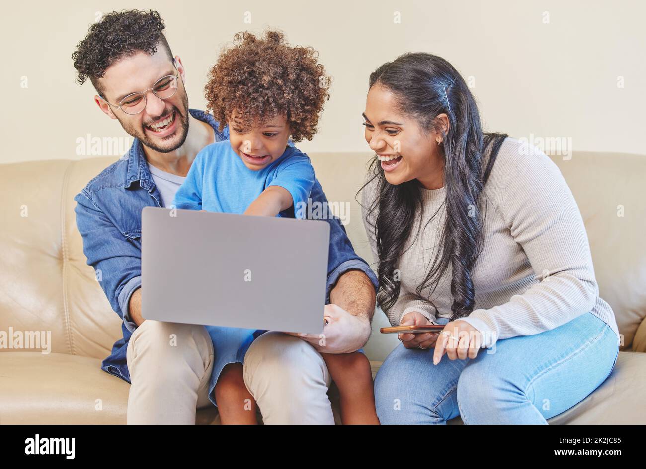 Make education fun again. Shot of a young family using a laptop together. Stock Photo