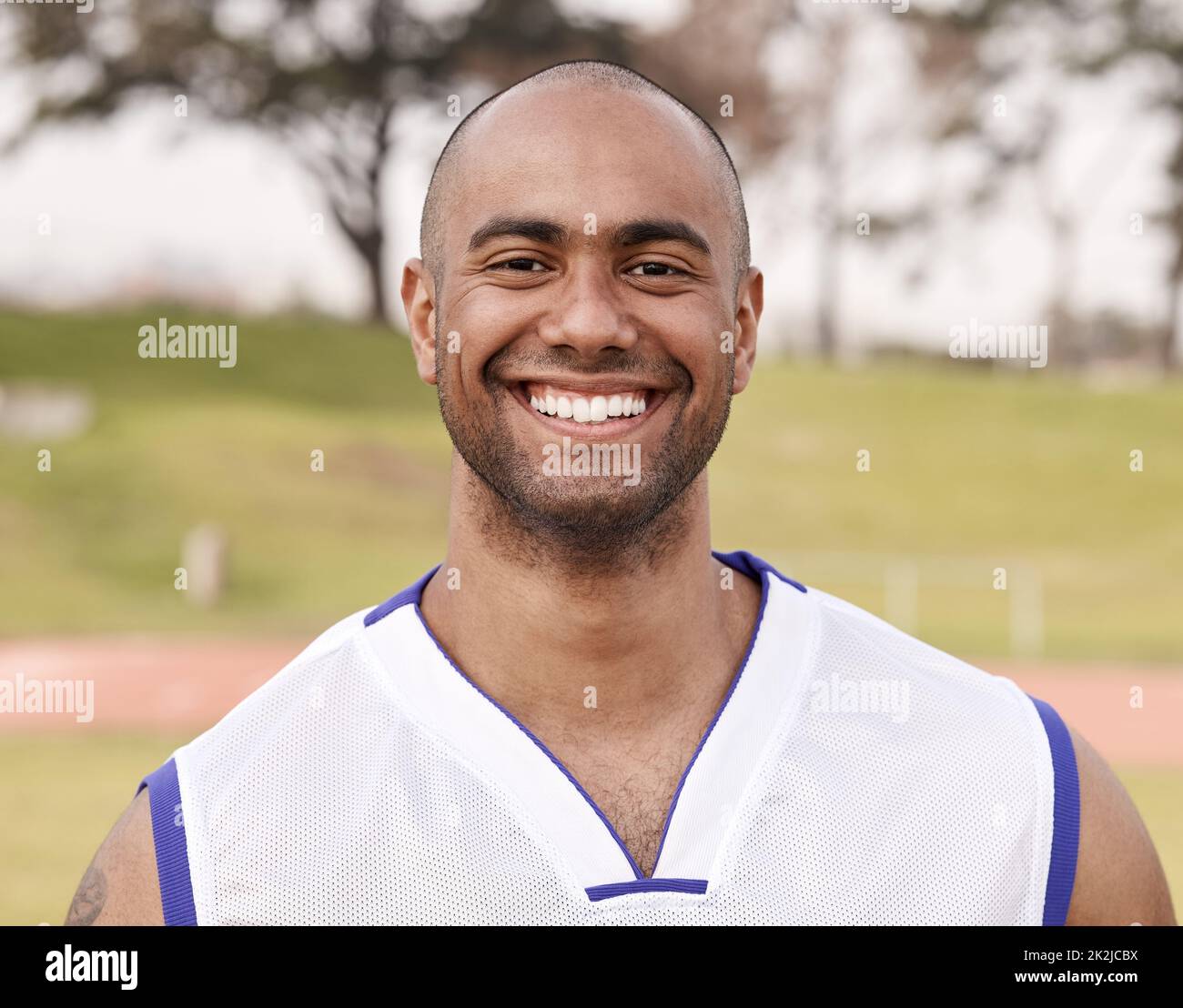 Happiness is being able to play sports. Shot of a handsome young man standing alone outside while playing sports. Stock Photo