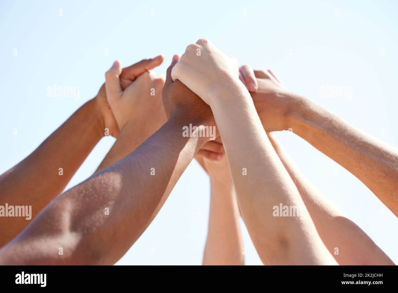 Supportive friends are the best friends. Shot of a group of unrecognizable people holding hands outside. Stock Photo