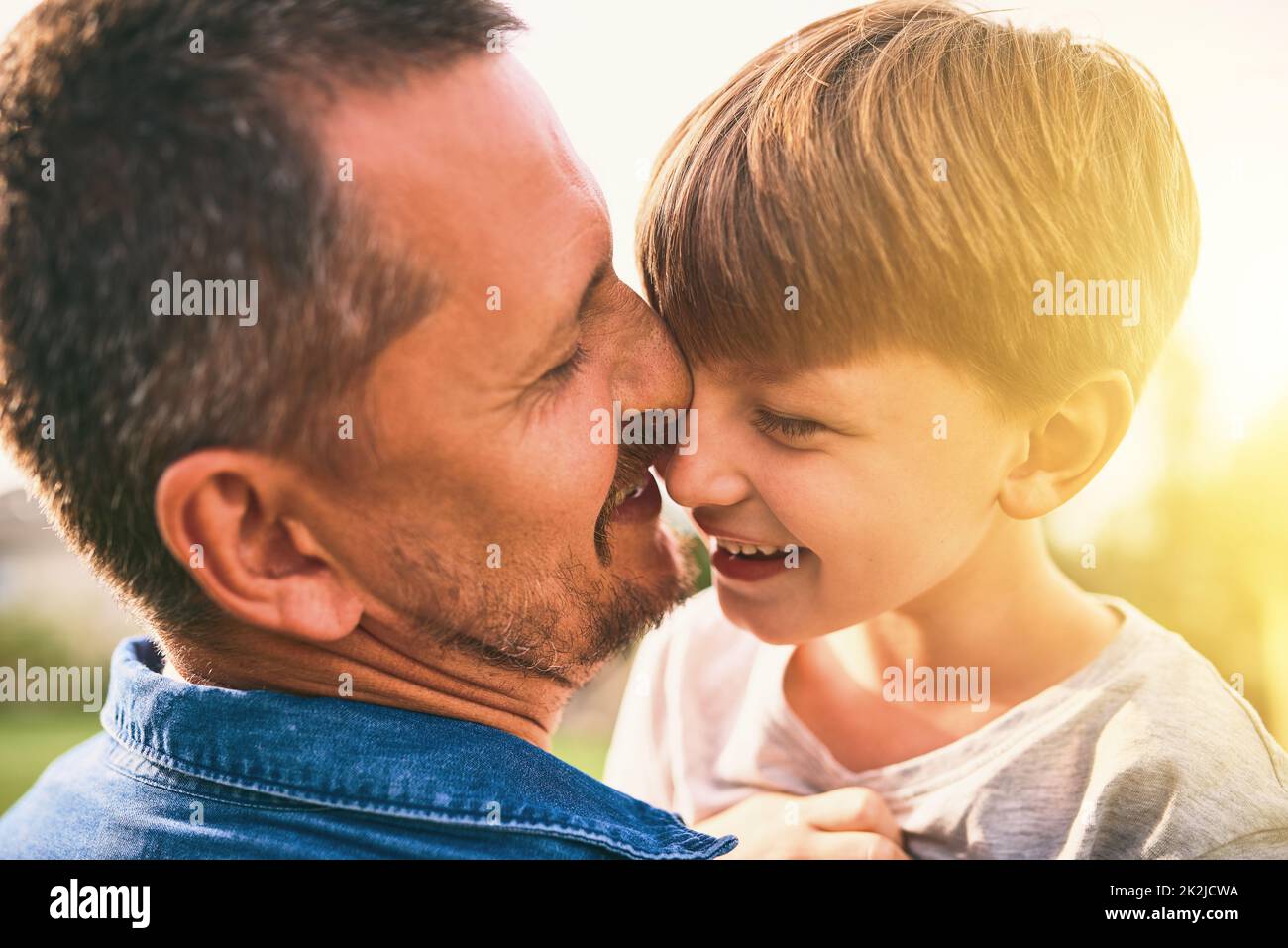 Aspiring to be a hero to his son. Shot of a father bonding with his adorable little son outdoors