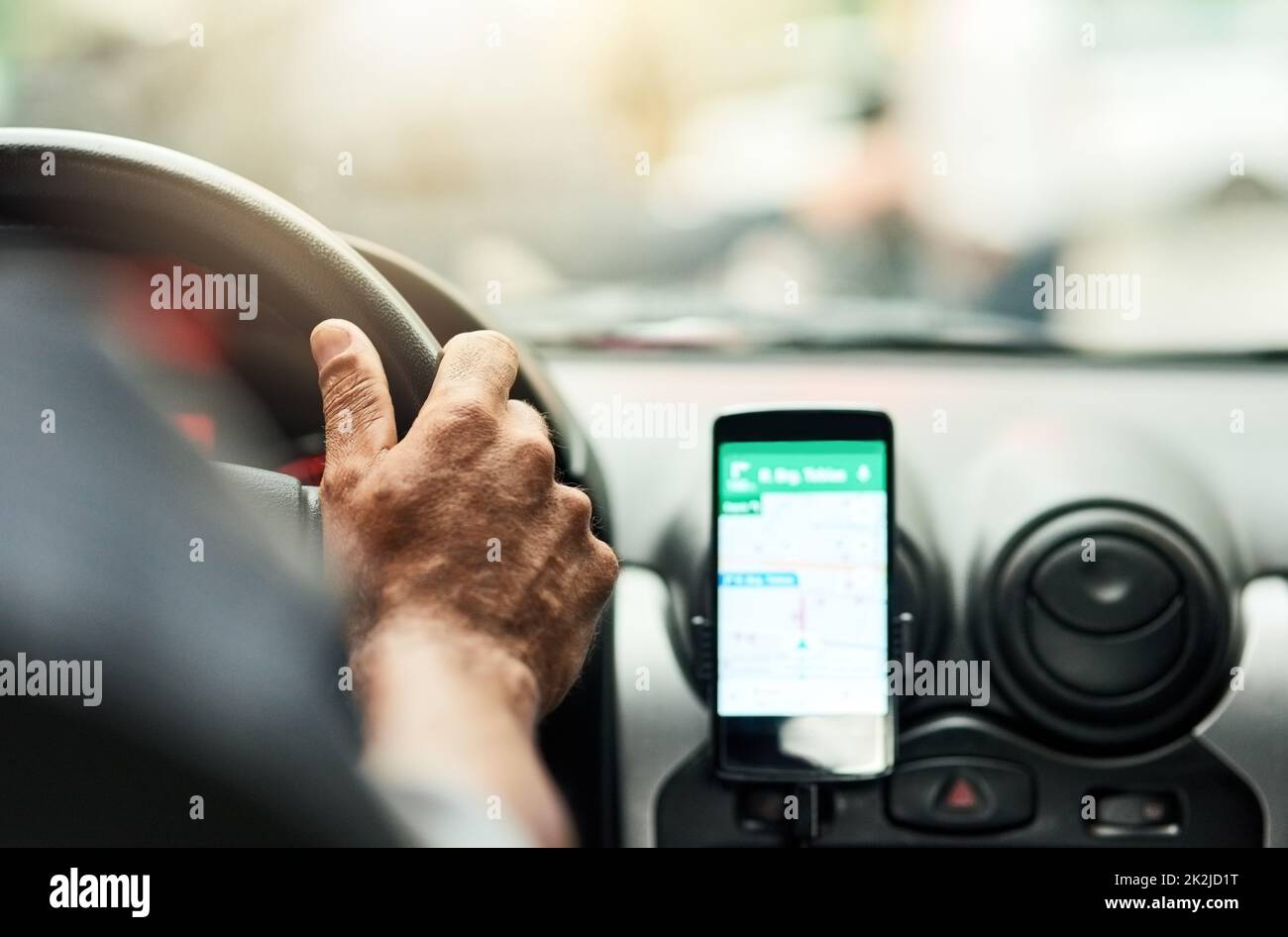 Youll never be lost with modern technology. Closeup shot of a man using a phone to find directions while driving. Stock Photo