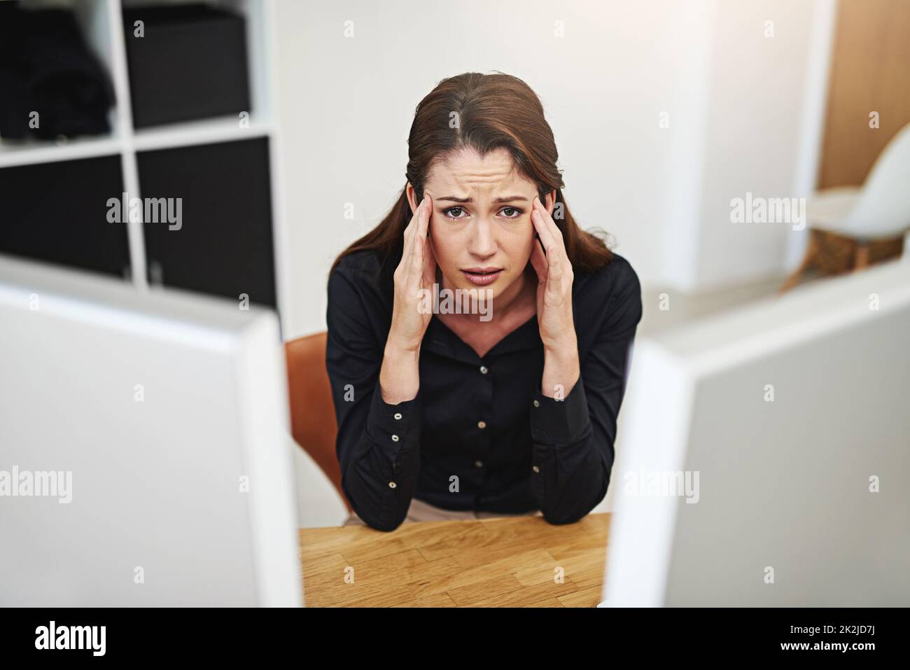 I dont want to be here. Portrait of a young businesswoman looking stressed out at her desk. Stock Photo