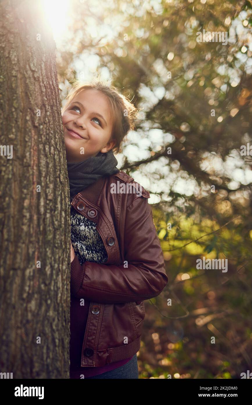 Adventure is out there. Shot of a little girl playing outdoors in a forest. Stock Photo