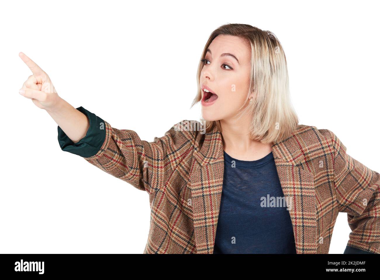 Whoa, wont you just look at that. Studio shot of a young woman pointing towards something. Stock Photo