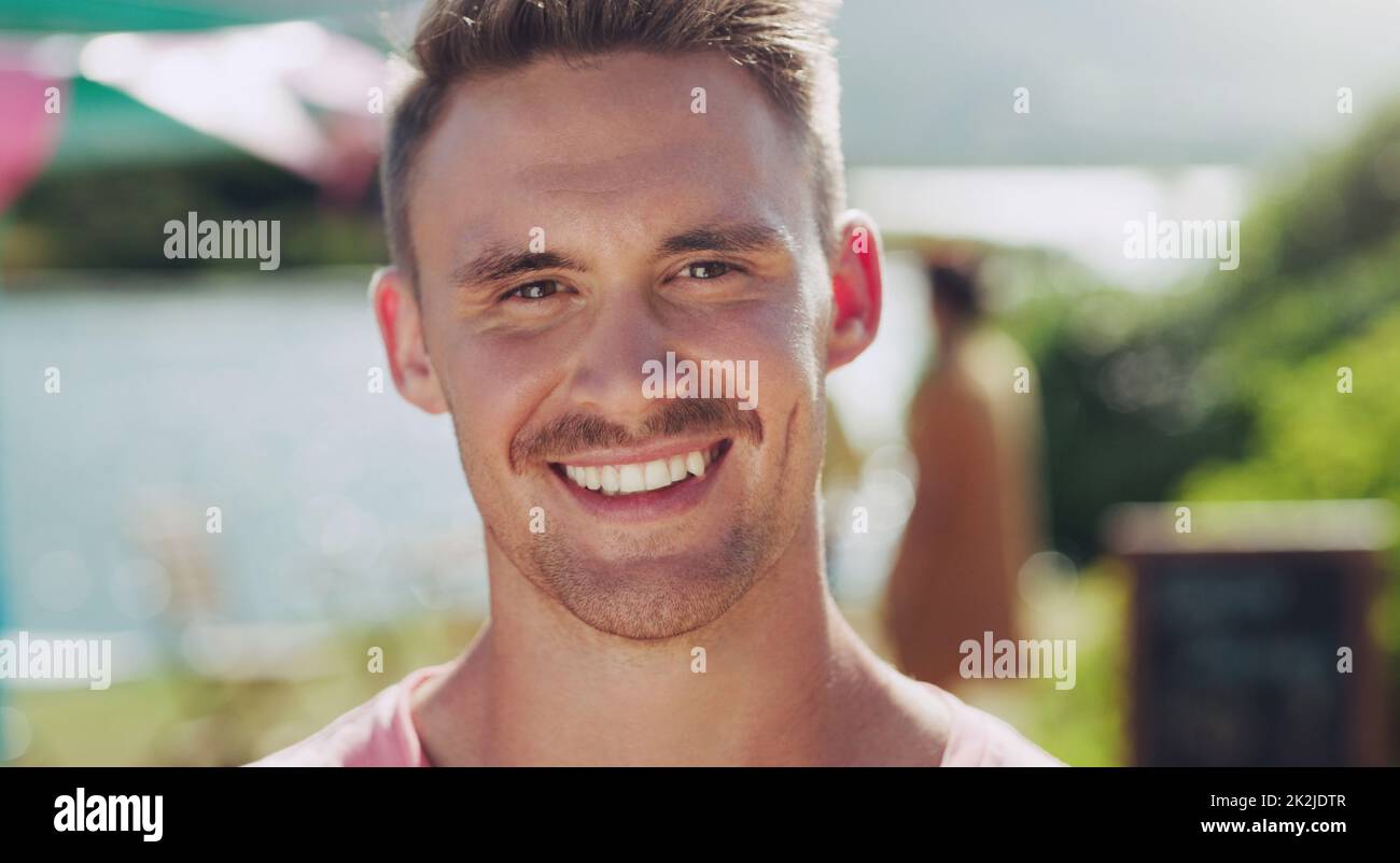 I love being outside in nature. Shot of a young man smiling while outside. Stock Photo