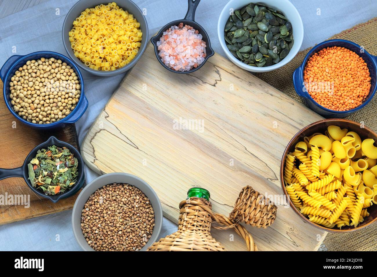 Different vegetarian organic products in bowls. Rural view. Top view. Copy space. Stock Photo
