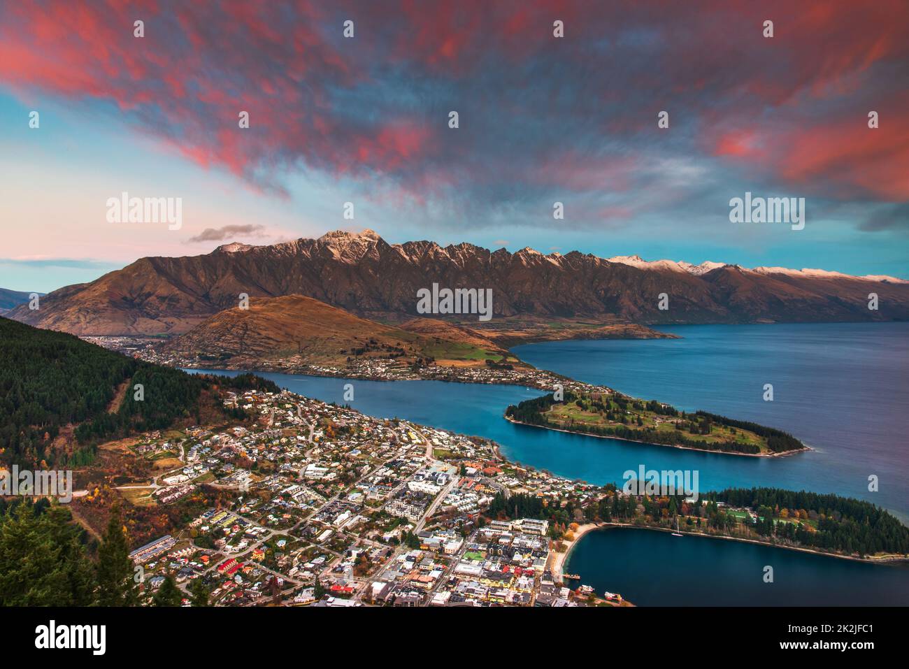 A view over Queenstown taken after sunset from the summit of Ben Lomond Mountain. Queenstown, Otago, New Zealand. Stock Photo