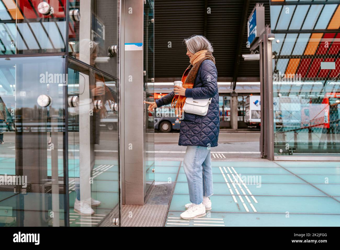 senior woman buys the train tickets with the automatic machine Stock ...