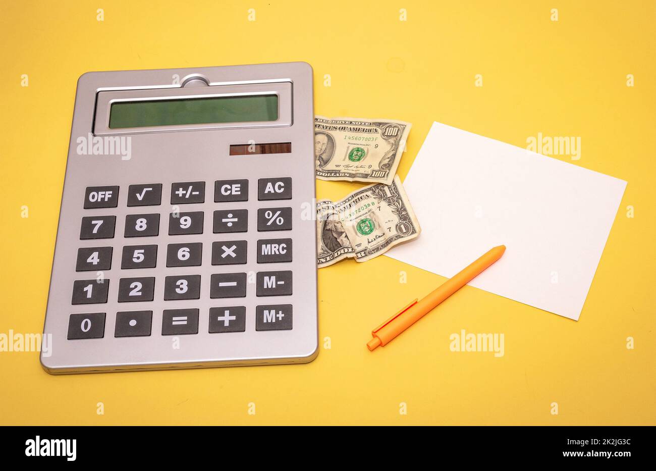 Large electronic calculator with US dollars bills Stock Photo