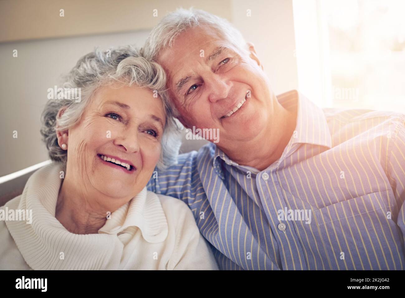 Reminiscing on all their wonderful experiences together. Cropped shot of a senior couple looking thoughtful at home. Stock Photo