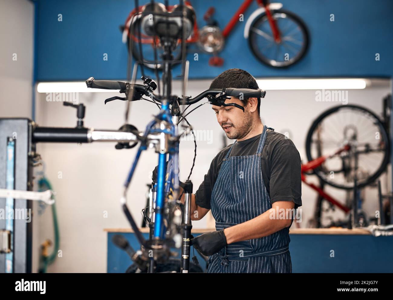 Giving your bike the attention it deserves. Shot of a man working in a