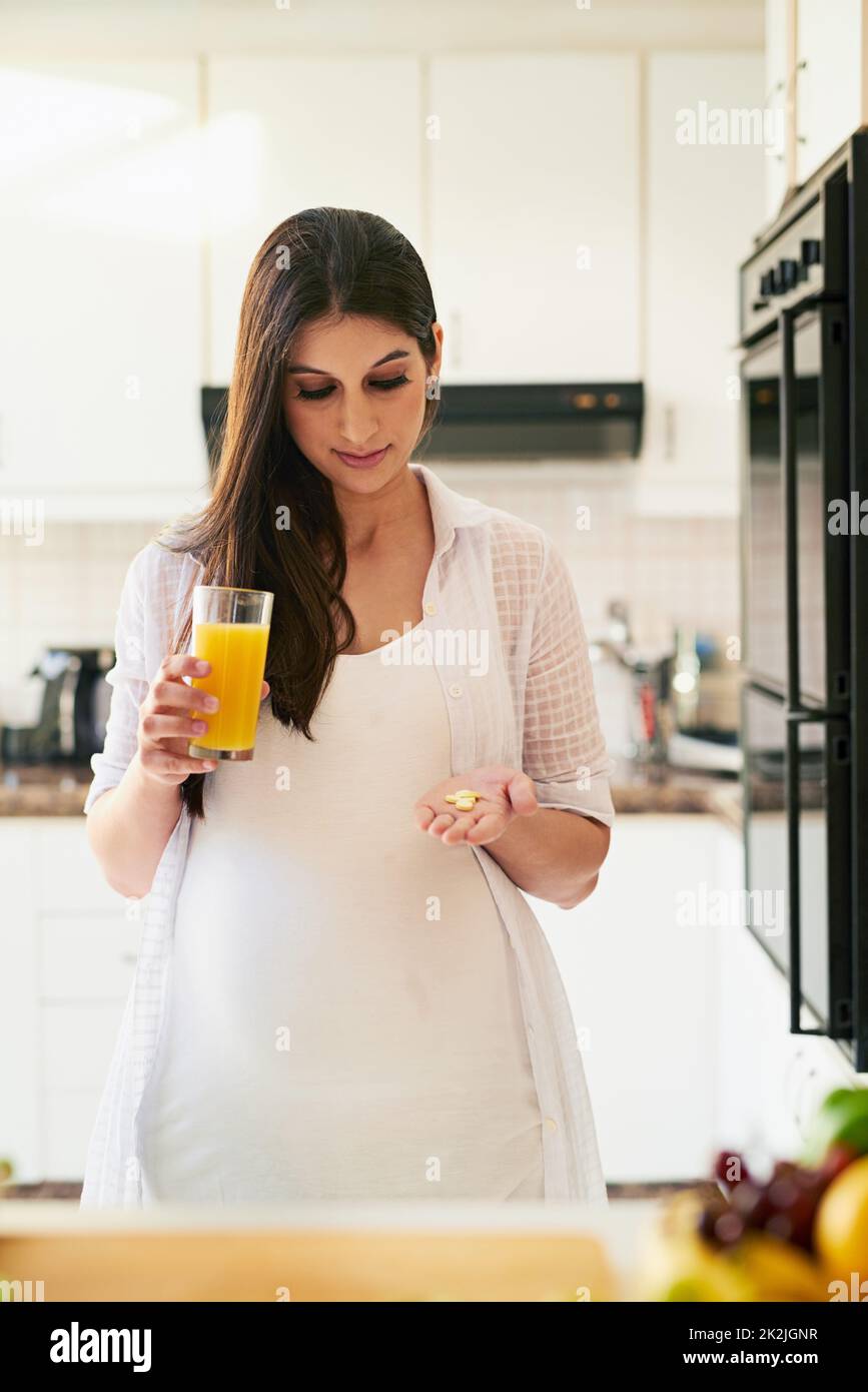 Some vitamin C to go with my vitamins. Shot of a young pregnant woman