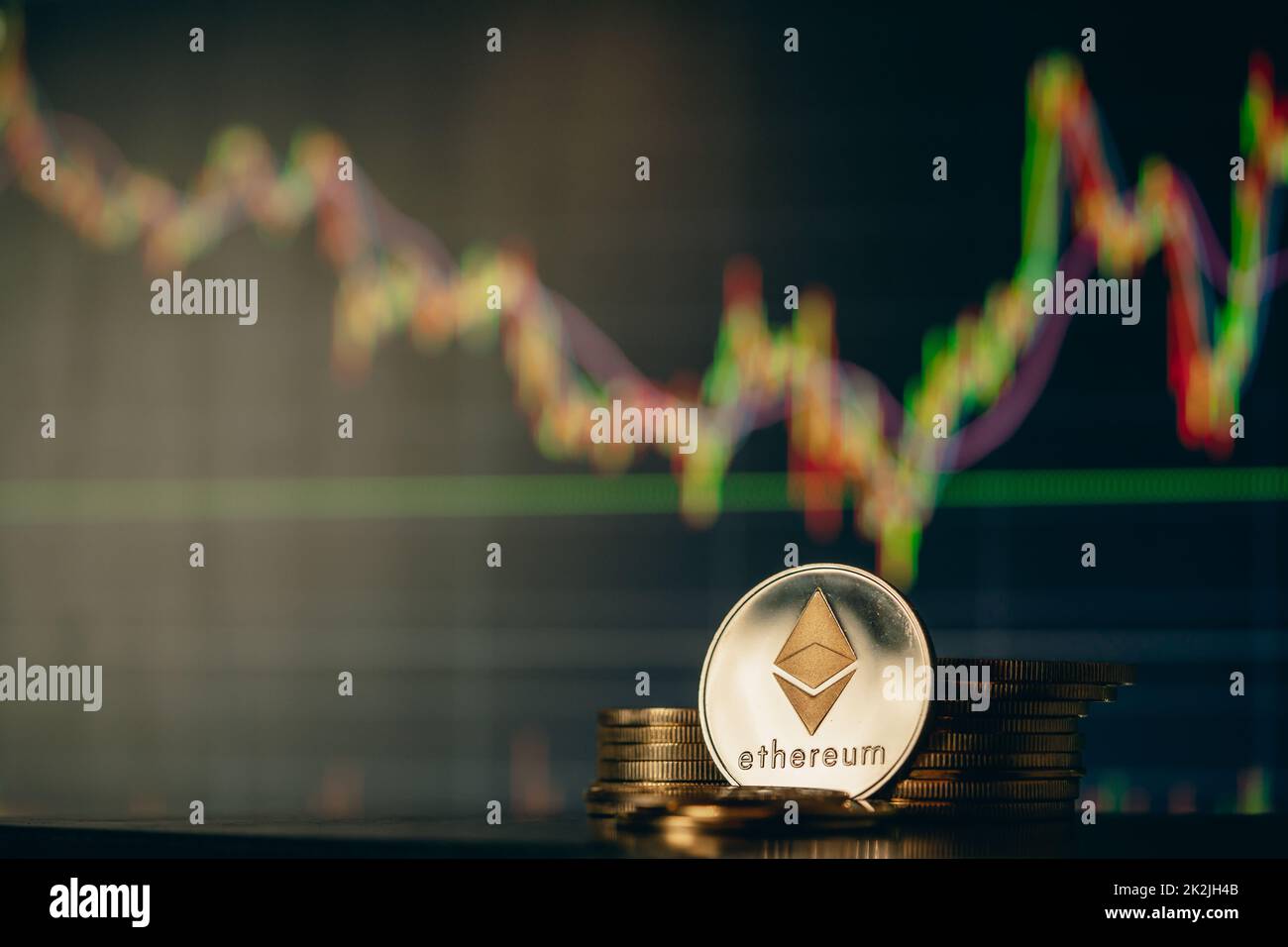 Stack or heap of silver Ethereum cryptocurrency with candle stick graph chart and digital background. Stock Photo