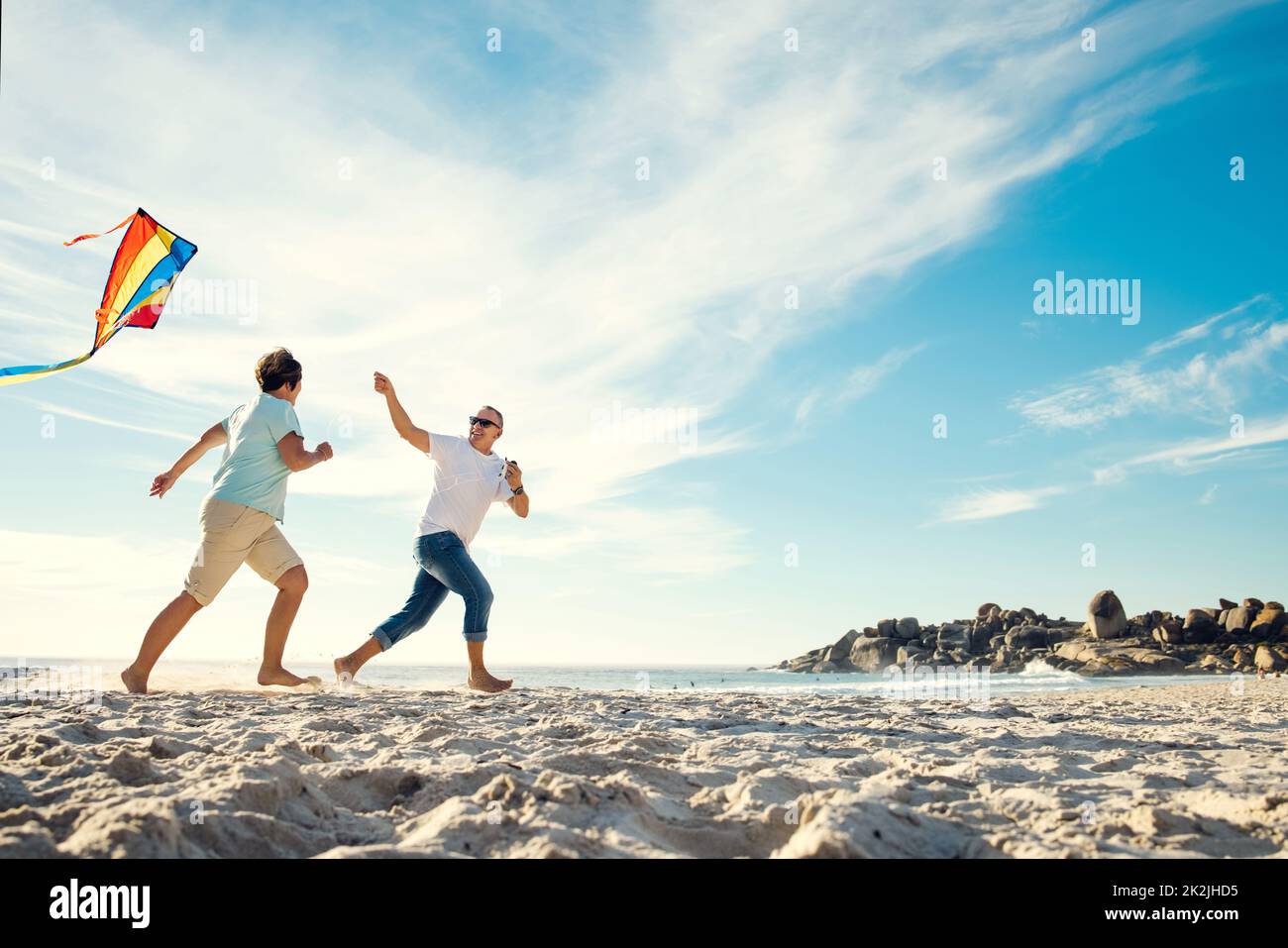 Kites bring joy to people of all ages. Shot of a mature couple on the beach with a kite. Stock Photo