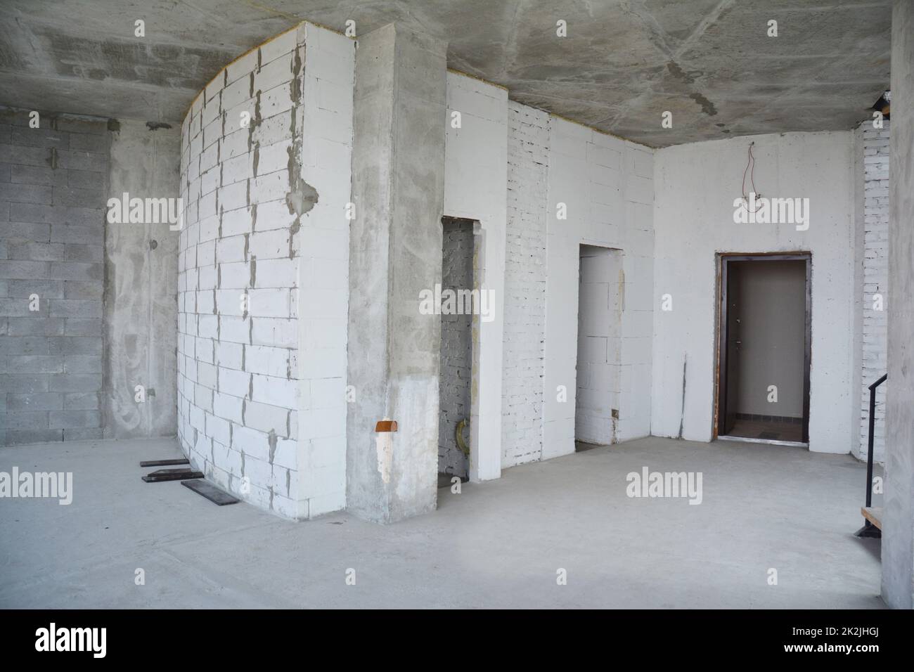 Interior hall room under construction, metal door lintels. Wall without plasterwork and ready to remodel Stock Photo