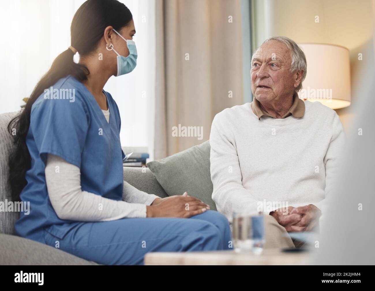 Taking care of you is her passion. Shot of a young female nurse having a checkup with an elderly patient at home. Stock Photo
