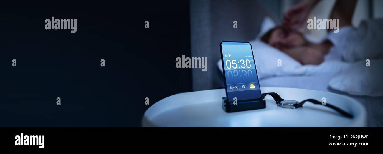 Man Waking Up With Alarm On Mobile Phone Stock Photo Alamy