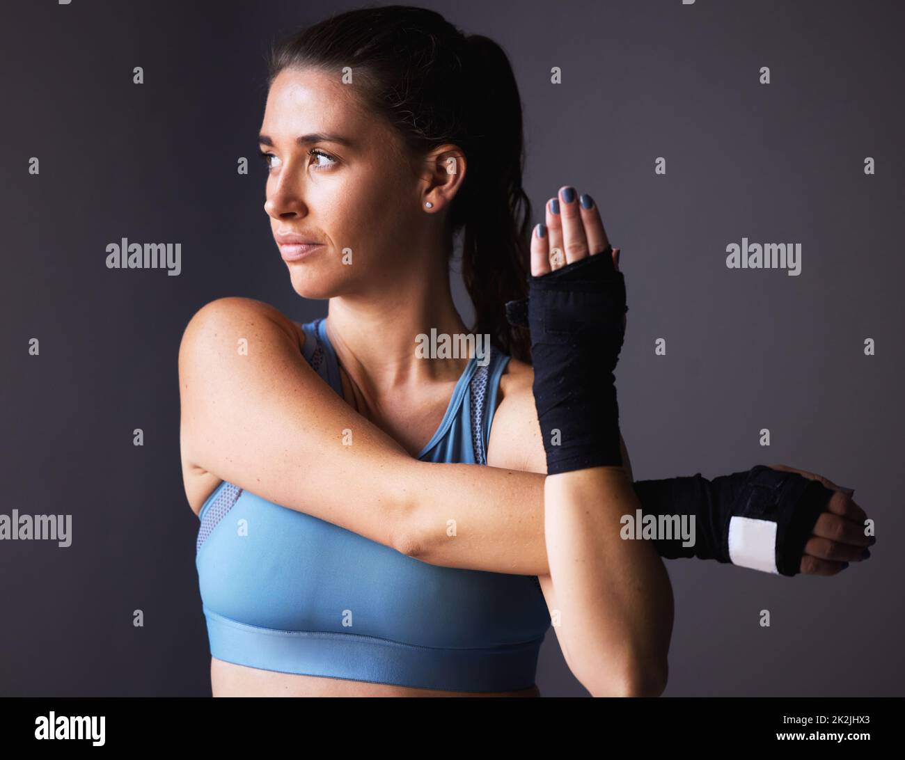 Its all in the mind shot of a young woman stretching her arms against