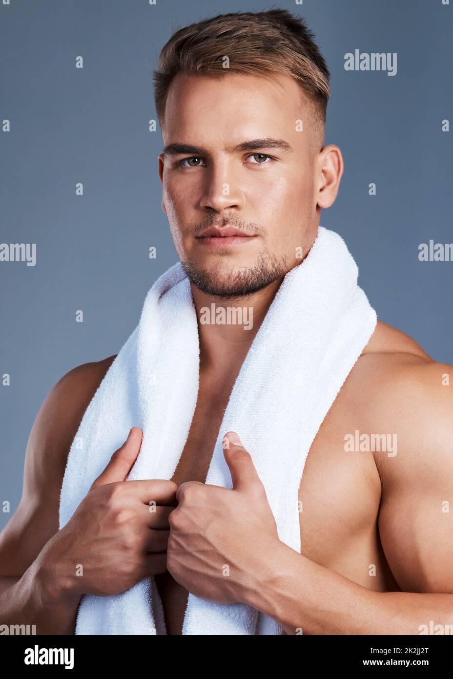 My skin is healthy and protected against dryness. Shot of a handsome young man posing with a towel around his neck. Stock Photo