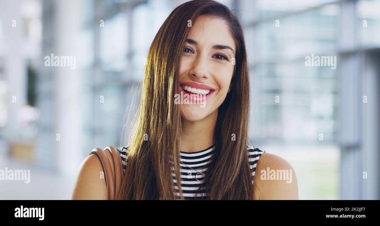 I'm on an accelerated career path. Cropped shot of a confident young businesswoman walking through a modern office. Stock Photo