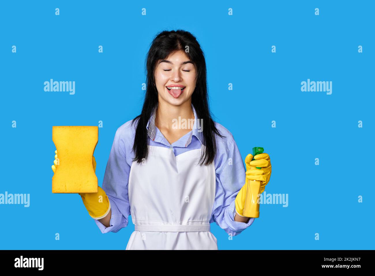woman gloves and cleaner apron with sponge and detergent sprayer Stock Photo