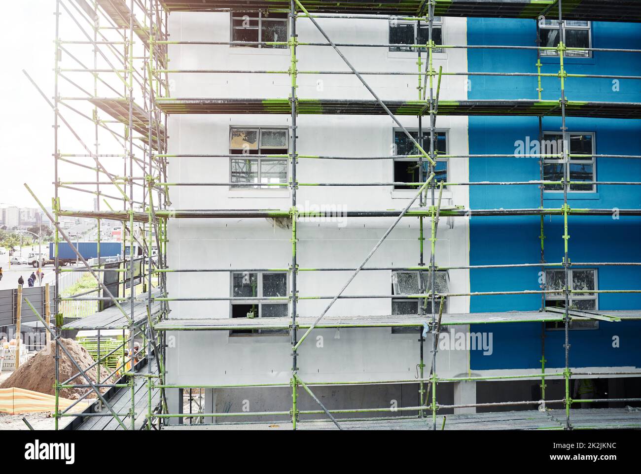 The demand for urban accommodation is on the rise. Shot of scaffolding and a building at a construction site. Stock Photo