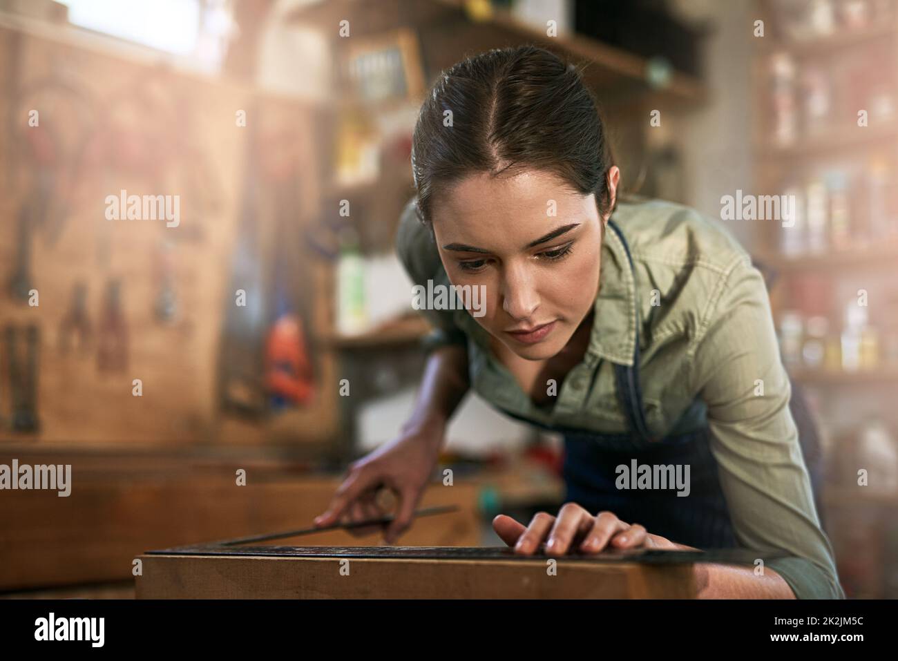 Making sure its perfect. Shot of a young female designer in her workshop. Stock Photo