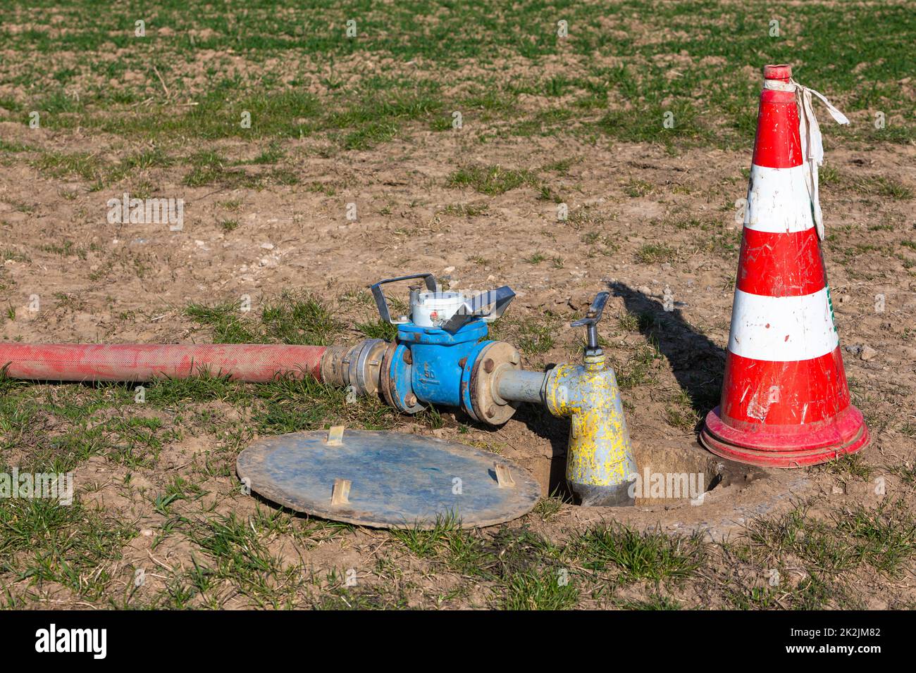 pipe with water meter with pump on the field Stock Photo