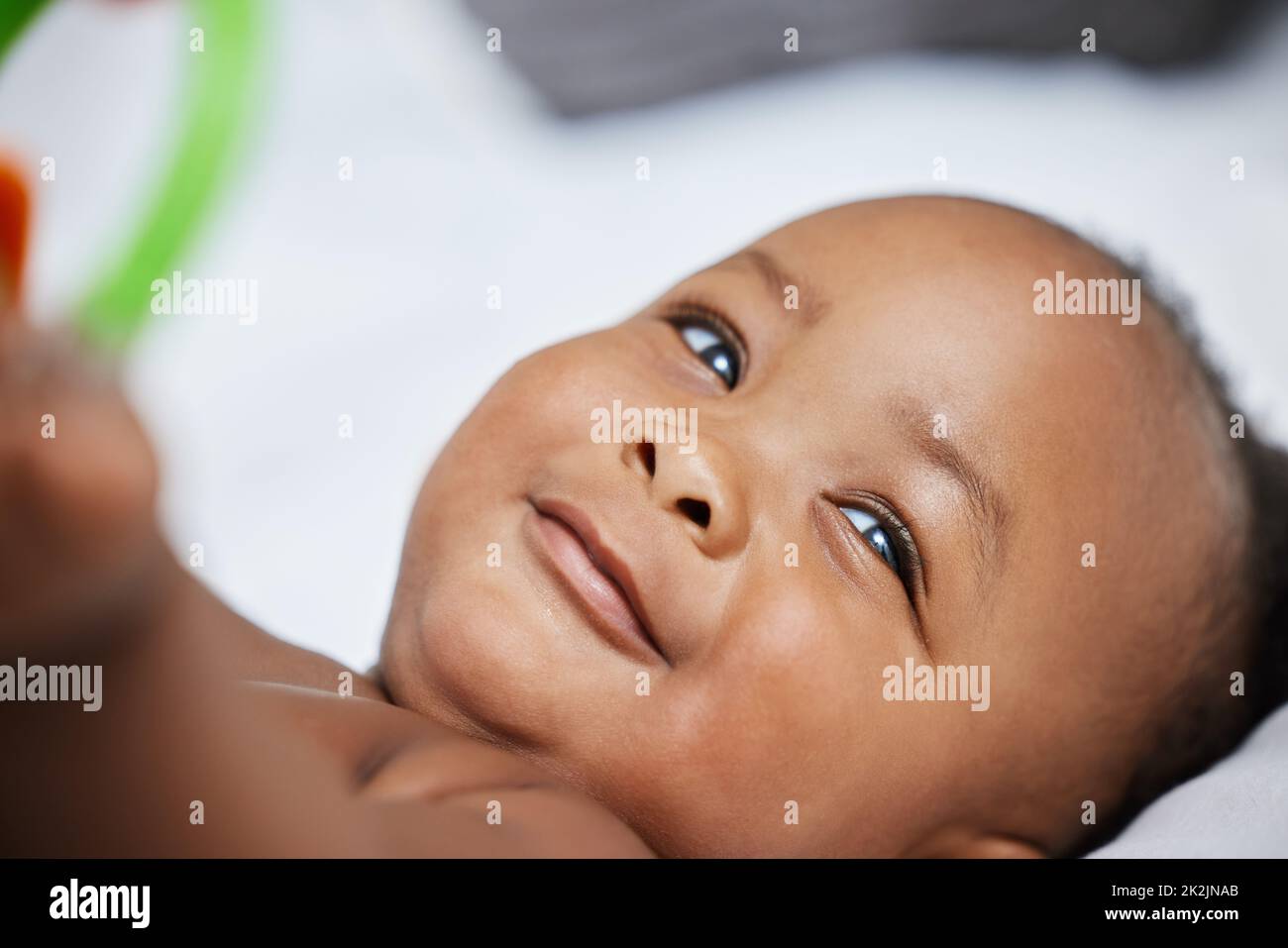 Mom says that Im the cutest baby. Shot of a little baby girl playing with toys in the doctors office. Stock Photo