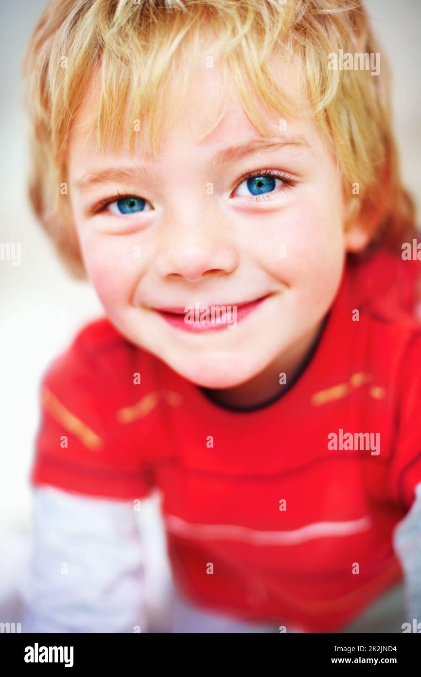 An innocent little boy giving you a cute smile. Closeup portrait of an innocent little boy giving you a cute smile. Stock Photo