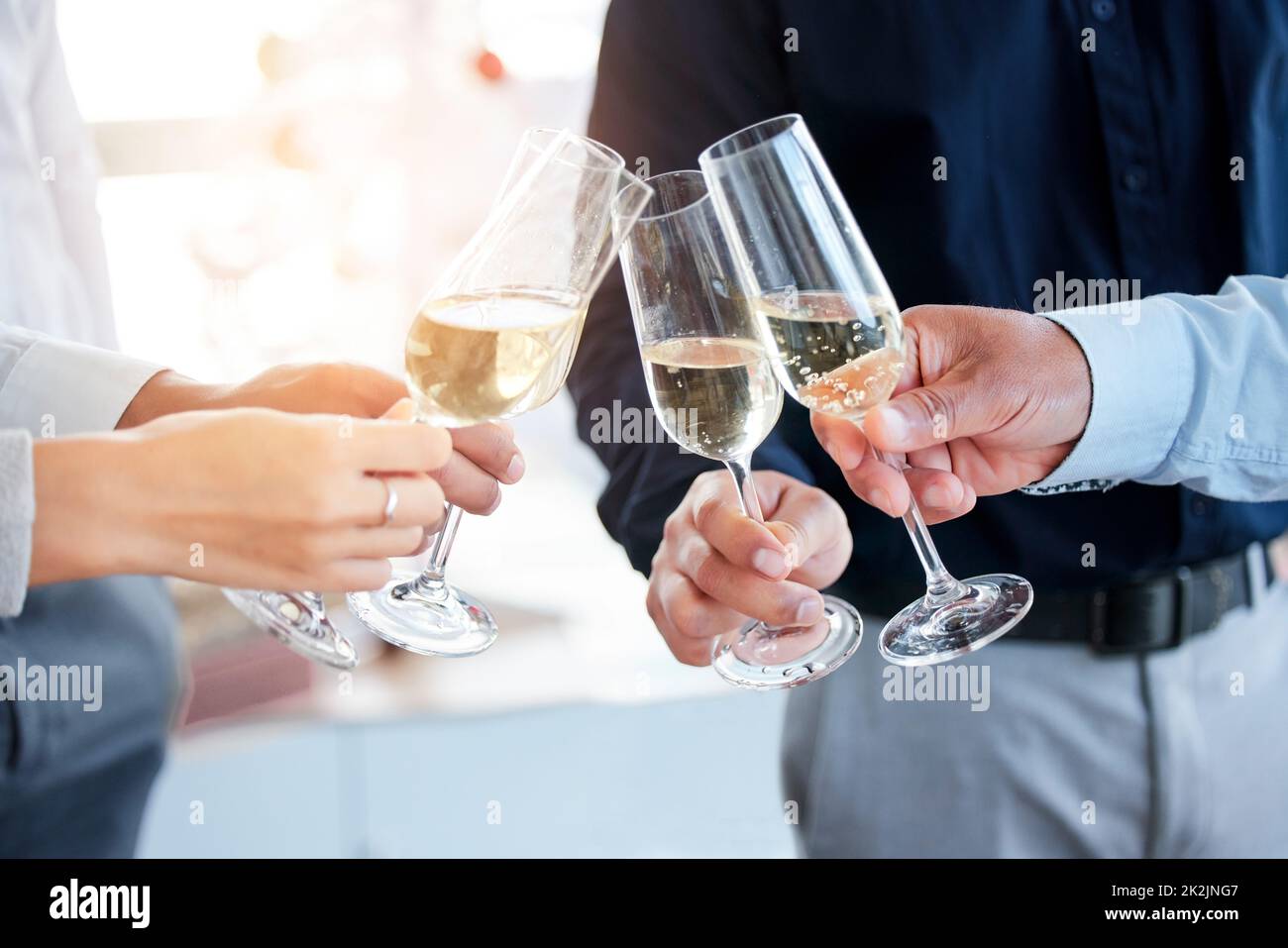Lets toast to success. Shot of a group of unrecognizable people toasting with wine glasses. Stock Photo