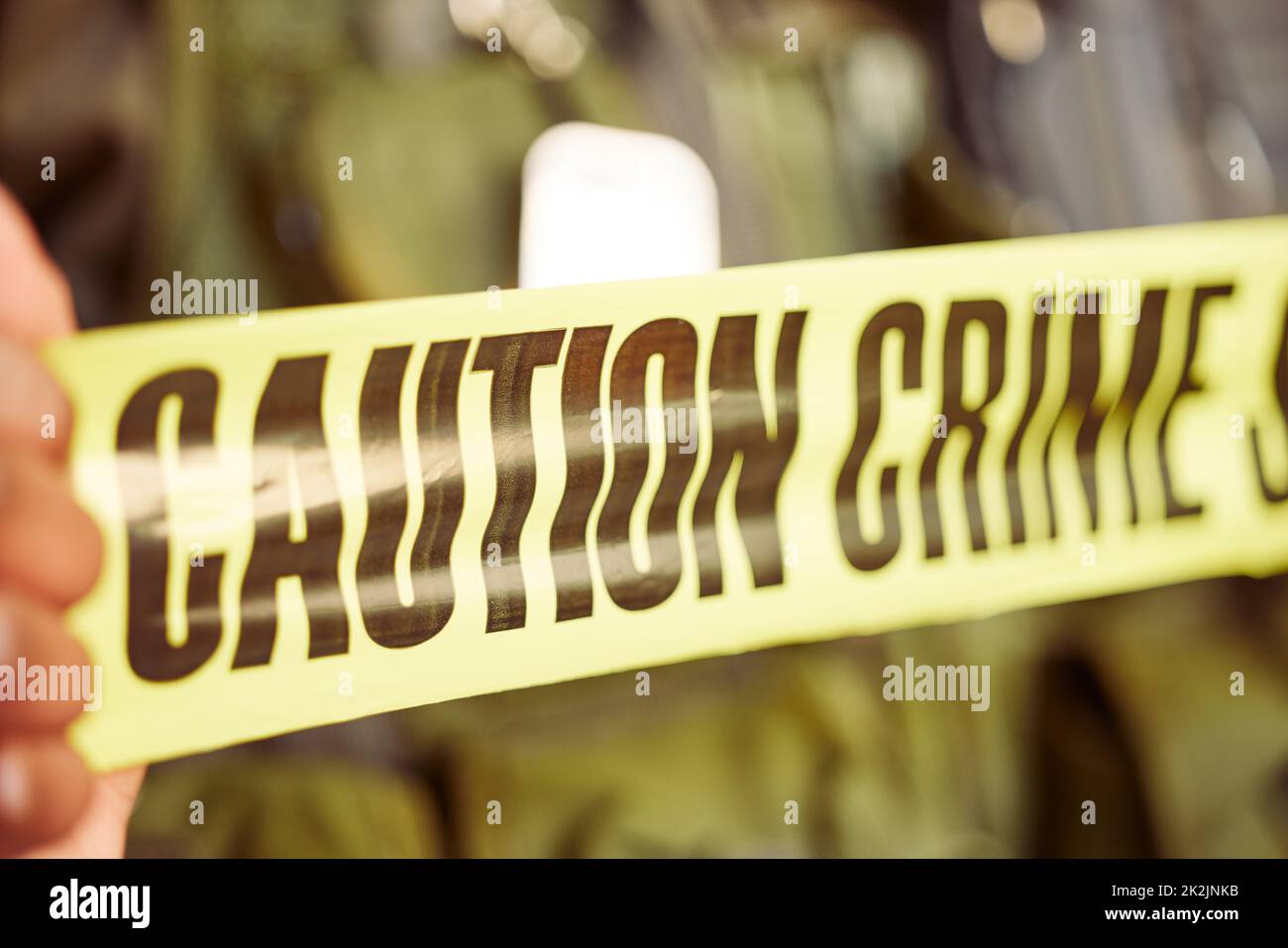 Well take care of this from here. Shot of caution tape surrounding a crime scene. Stock Photo