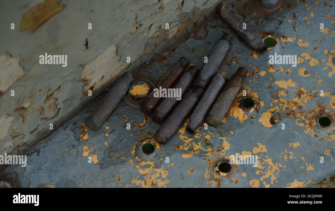 Empty rifle shells casing on abounded BTR armored personnel carrier. Stock Photo
