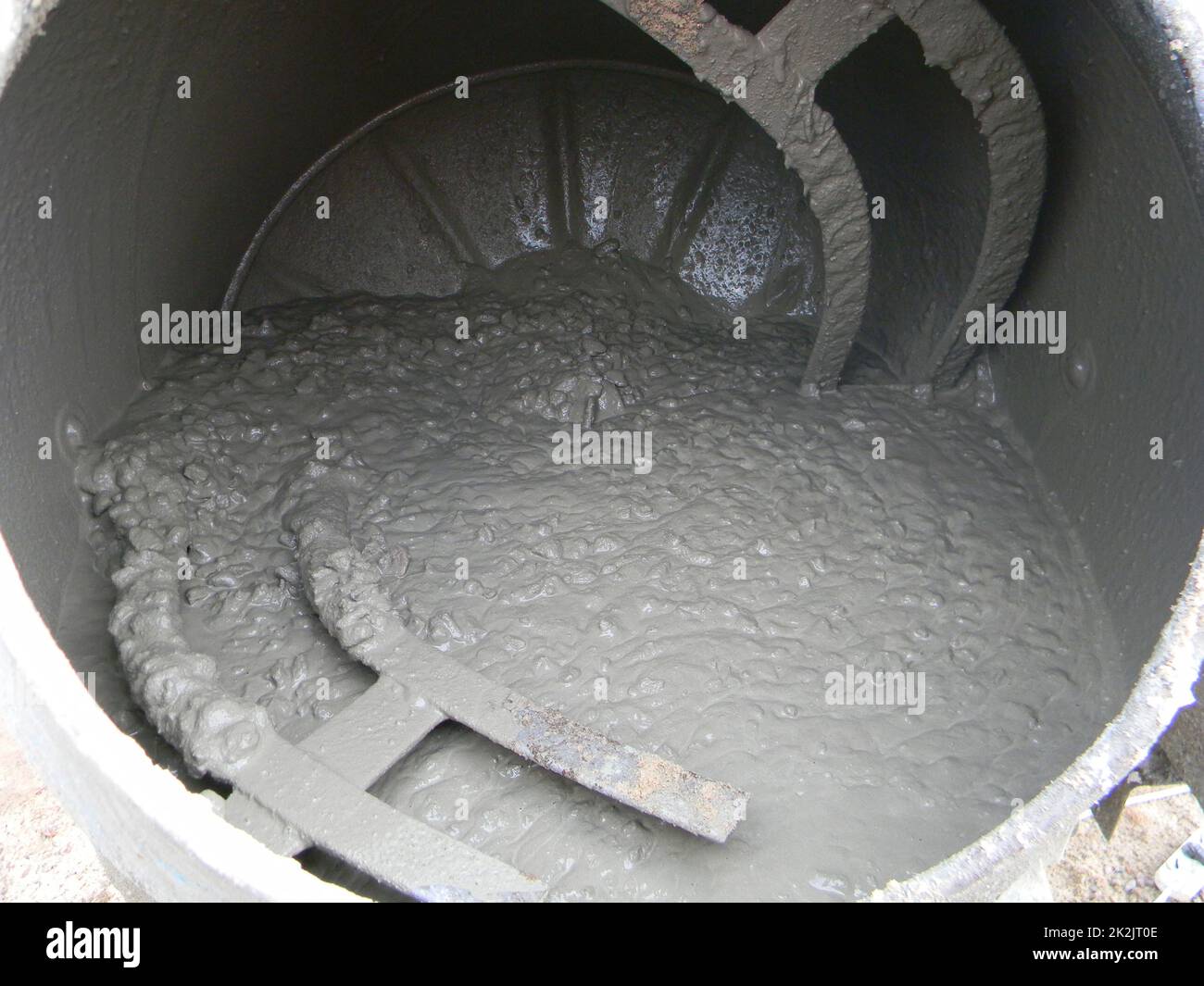 Concrete mixer with pouring cement. Close up on concrete mixer, cement mortar mixing. Stock Photo