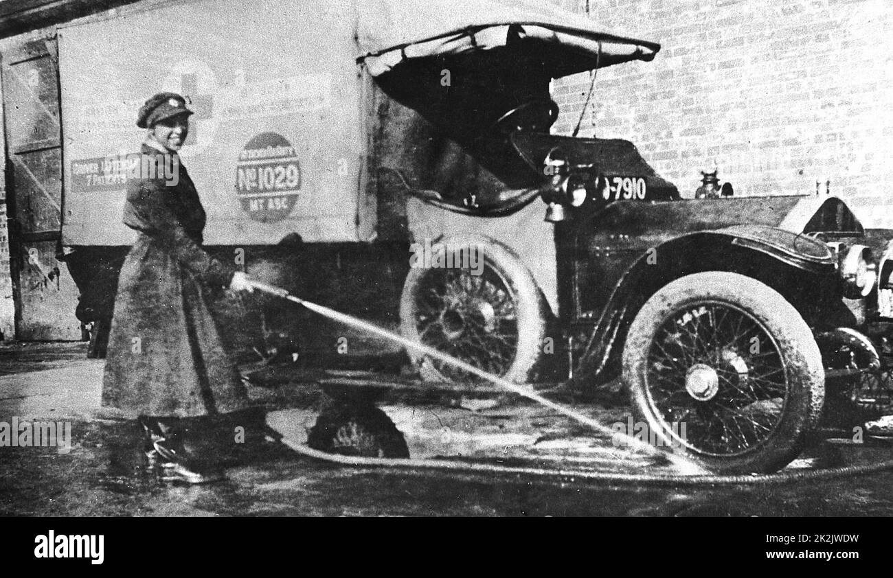 World War I: Volunteer English woman driver washing down her ambulance, a converted Wolseley, donated towards the war effort: Cambridge 1915 Stock Photo