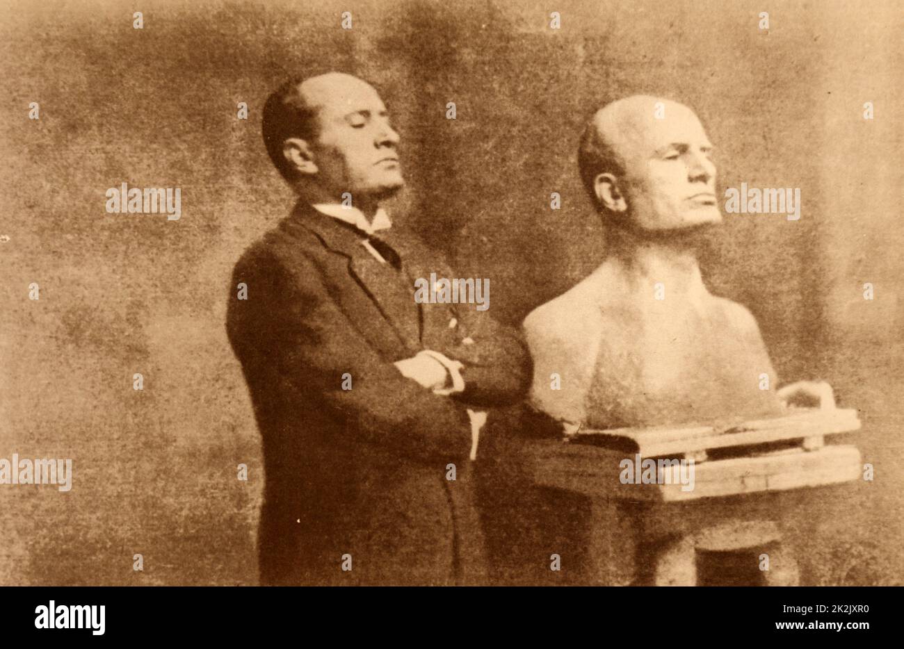 Photograph of Benito Mussolini (1883-1945) an Italian politician, dictator, and journalist, posing for his bust. Dated 20th Century Stock Photo