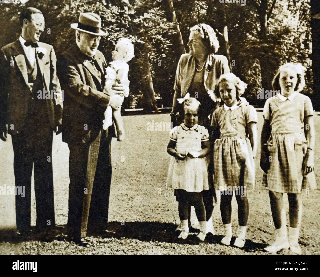 Photograph of Princess Juliana of the Netherlands (1909-2004), Sir Winston Churchill (1874-1965) and Prince Bernhard of Lippe-Biesterfeld (1911-2004) with their children. Dated 20th Century Stock Photo