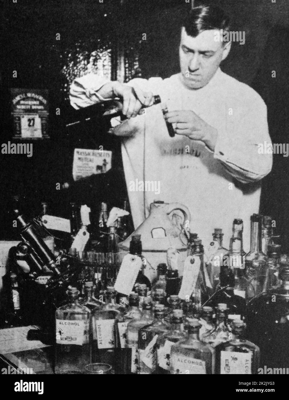 Mr William D McNally, coroner's chemist in chicago, testing samples of liquor seized by the police. Wood alcohol was found in many of these samples. Stock Photo
