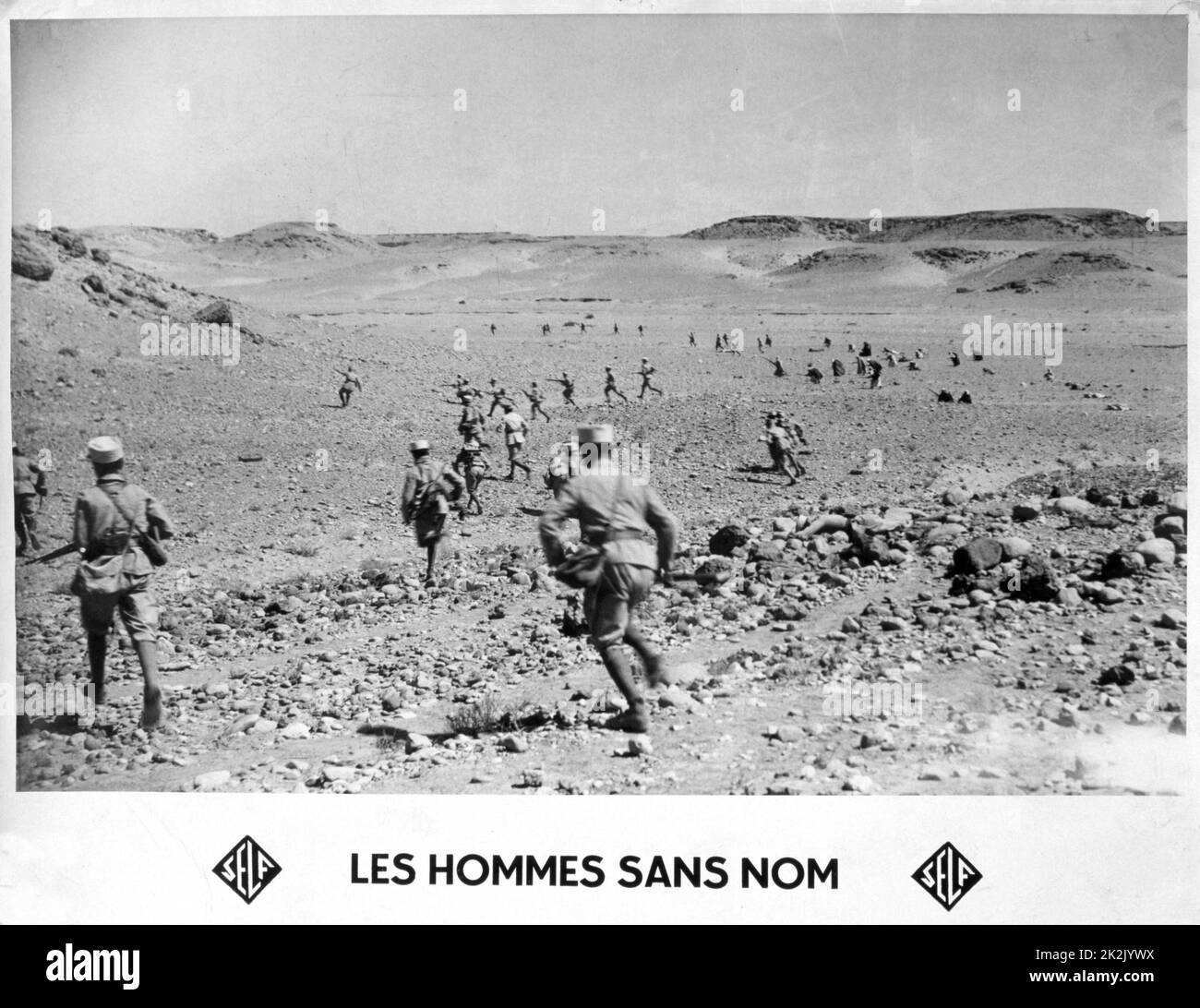 'Les Hommes sans nom' (The Men Without Names):  Early 20th century postcard of members of the French Foreign Legion in action. Stock Photo