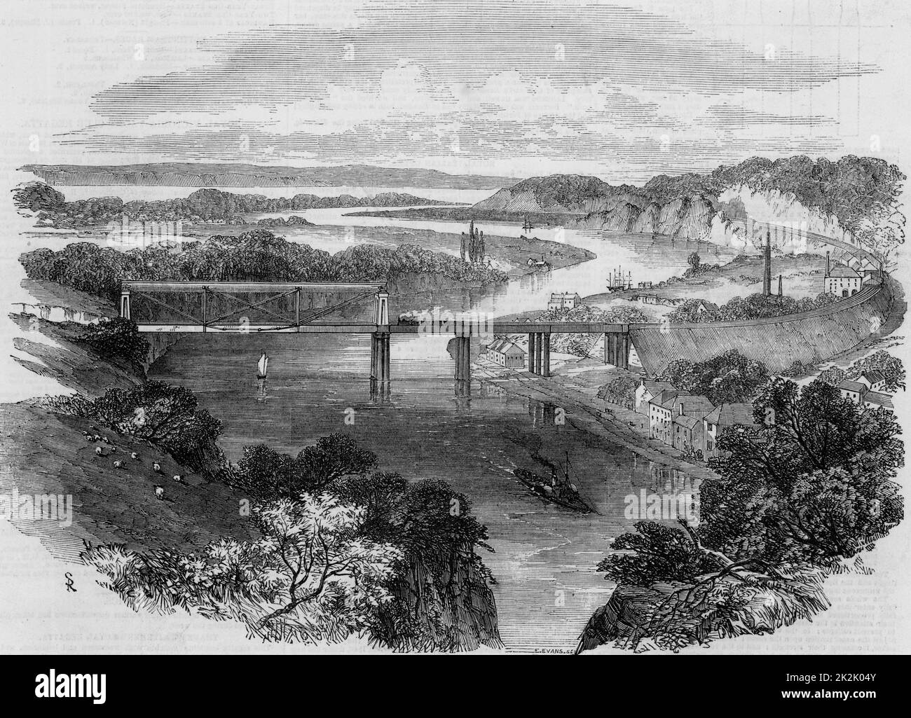 South Wales Railway: Opening of the Chepstow Bridge, 1852. Wrought iron tubular suspension bridge over the river Wye at Chepstow.  This bridge, constructed 1849-1852, was an innovative design by Sambaed Kingdom Brunel (1806-1859) and the use of wrought iron tubular girders is considered to be a dummy run for his last great masterpiece, the Royal Albert bridge over the Tamar at Saltash.   The Chepstow bridge carried the South Wales Railway over the Wye just above its junction with the Severn. Brunel was engineer to the railway.   From 'The Illustrated London News'. (London, 24 July 1852). Stock Photo