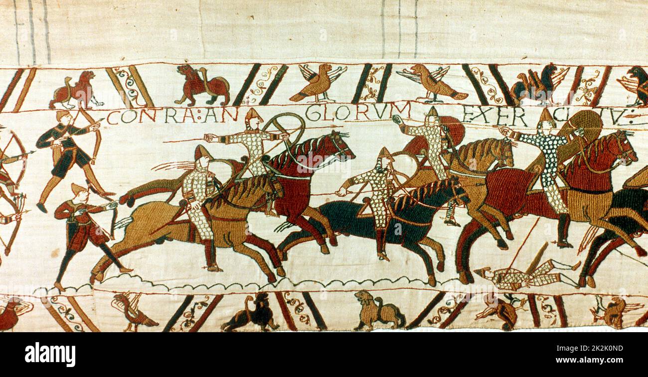 Bayeux Tapestry 1067: Battle of Hastings, 14 October 1066. Norman cavalry with spears and shields, backed up by archers, charging towards English. Norman Invasion Anglo-Saxon Textile Linen Stock Photo