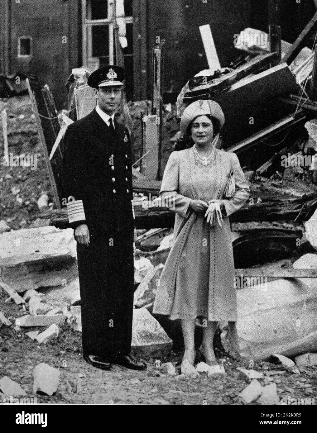 King George V and Queen Elizabeth, stand in the ruins of Buckingham Palace after an air raid in World War II Stock Photo