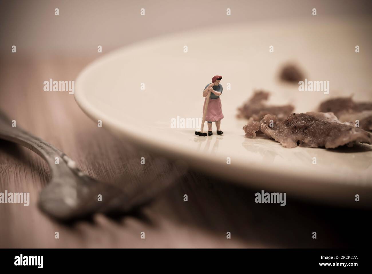 Miniature Housemaid Washing Dishes. Macro photo Stock Photo