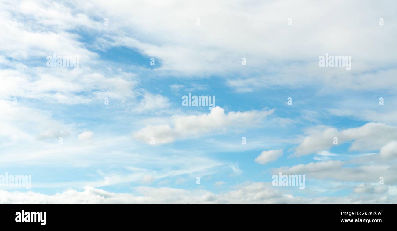 White fluffy clouds on blue sky. Soft touch feeling like cotton. White puffy cloudscape. Beauty in nature. Close-up white clouds texture background. Sky on sunny day. Summer sky with fresh air. Stock Photo