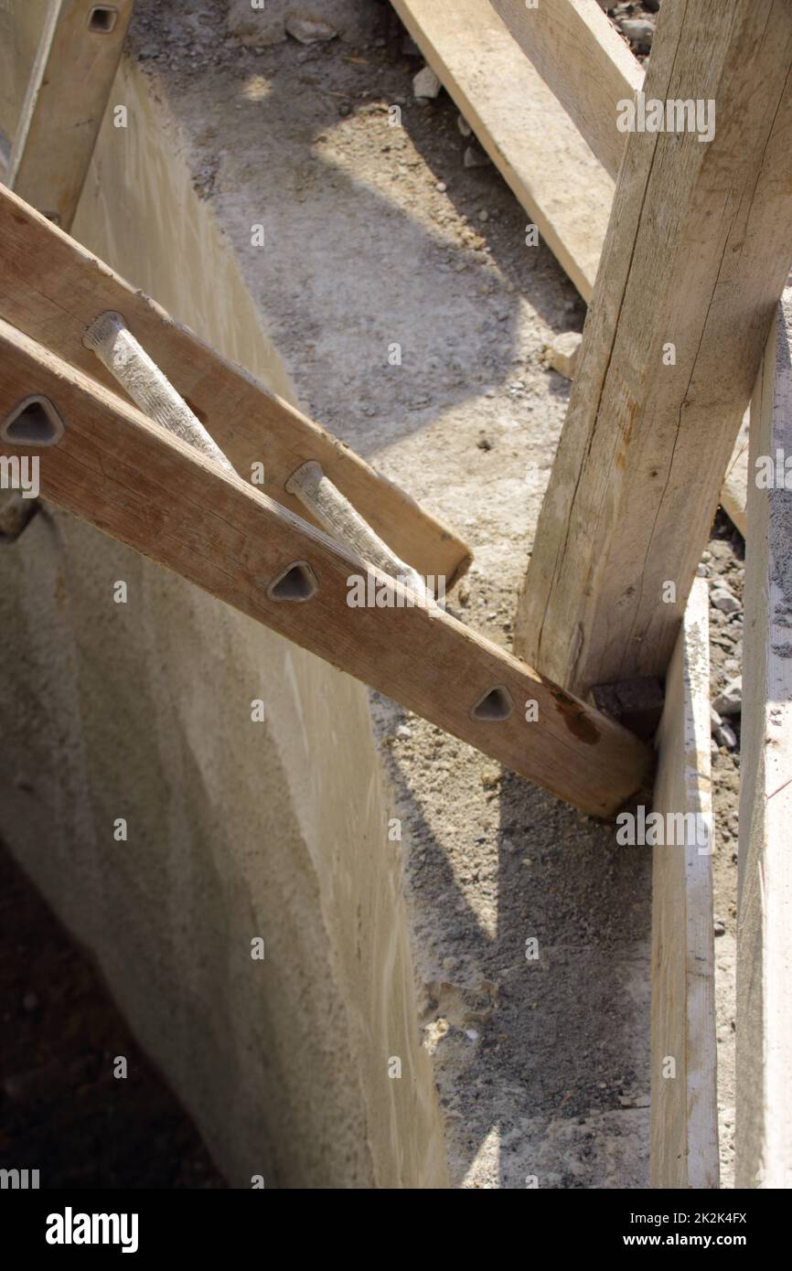 ladder is at risk of falling over a pit Stock Photo