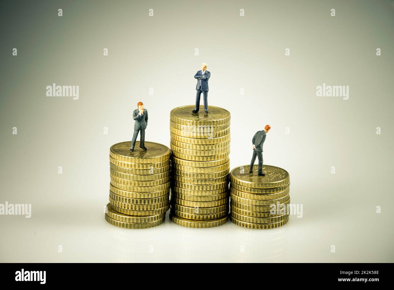 Business people on pile of coins. Business competition concept Stock Photo
