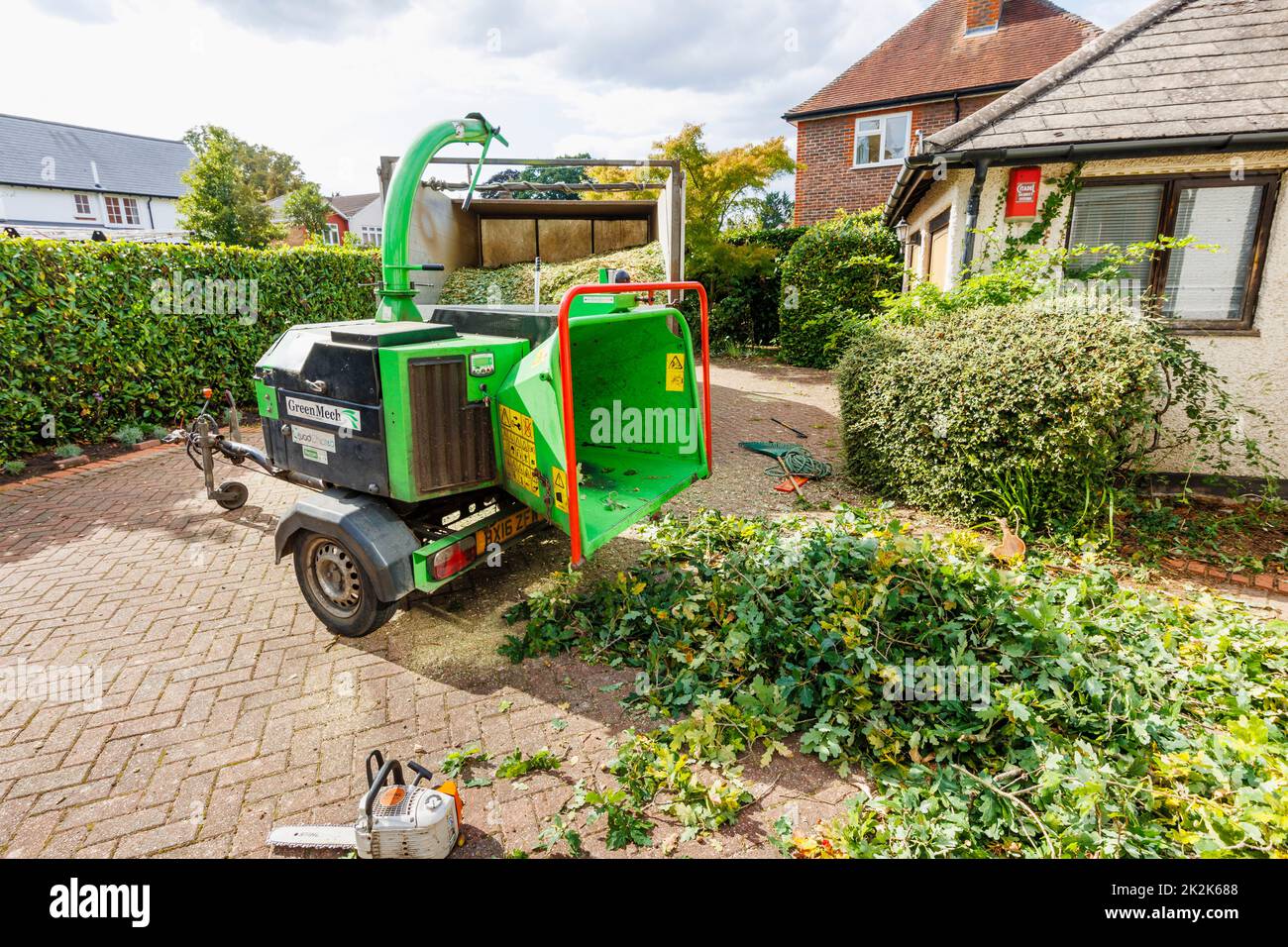 A commercial GreenMech Quadchip 160 woodchipper in operation in Surrey, south-east England disposing of trimmings from felling a garden oak tree Stock Photo