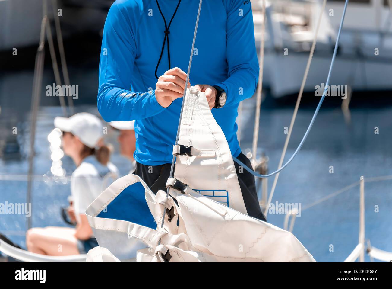 Midsection of a yachtsman checking sail before competition Stock Photo